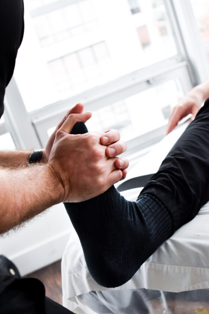 physiotherapist treating runner to prevent running injuries in Vancouver